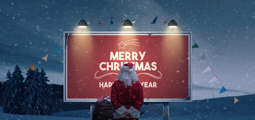 Santa Claus reading Christmas wishes on a billboard sign