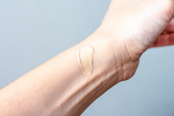 Sample of foundation on hand. Close-up of a wrist with a sample of foundation to test against a...