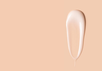 cosmetic smears of creamy texture on a beige background