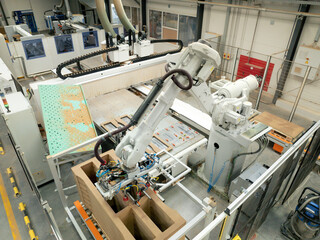 Industrial automation and robotics in modern industrial factory. High precision robotic arm...