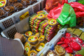Many varieties of traditional snacks sold in the Marketplace in dawn time in Surabaya, East Java, Indonesia.