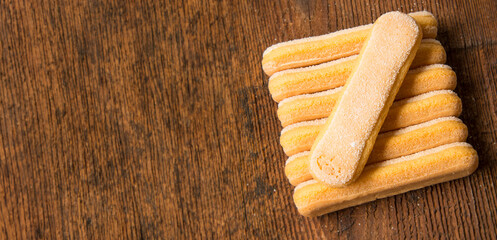 sponge biscuit - ladyfinger savoiardi on a wooden table