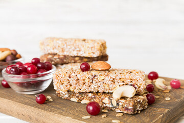 Various granola bars on table background. Cereal granola bars. Superfood breakfast bars with oats, nuts and berries, close up. Superfood concept