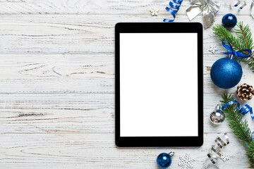 Digital tablet mock up with rustic Christmas decorations for app presentation top view with empty...