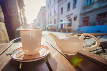 cup of tea and teapot on the table in outdoor cafe in Lviv.