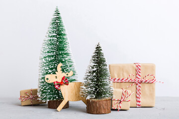 Christmas composition. Gifts, small tree, branches and craft DIY decorations on white background. New year concept. Christmas home decoration Flat lay, top view, copy space