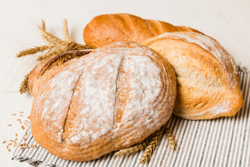 Homemade natural breads. Different kinds of fresh bread as background, perspective view with copy space