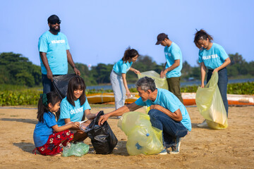 Team of young and diversity volunteer worker group enjoy charitable social work outdoor in cleaning up garbage and waste separation project at river beach - obrazy, fototapety, plakaty