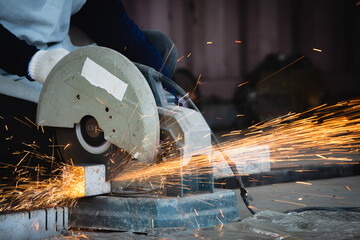 Heavy Industry Engineering Factory Interior with Industrial Worker Using Angle Grinder and Cutting...