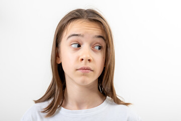 Little girl looks to the side in surprise on a white background isolated.