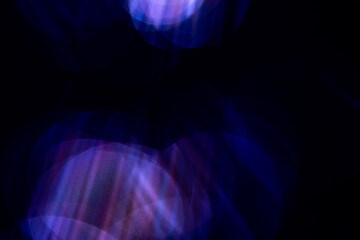 Blur purple rainbow crystal light leaks on black background. Defocused abstract multicolored retro...