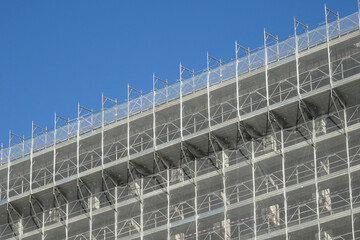 renovation of the external facade of a building, metal scaffolding and protection net
