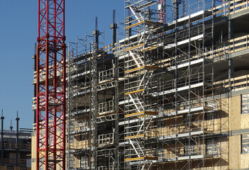 scaffolding on building under construction, external service staircases
