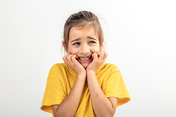 Scared and anxious girl, biting her fingernails on a white background isolated.