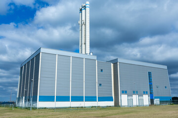 building of a modern chemical plant with pipes against a blue sky