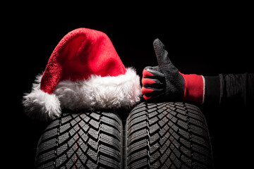 Car tire service and hands of mechanic holding new tyre on black background with copy space for text