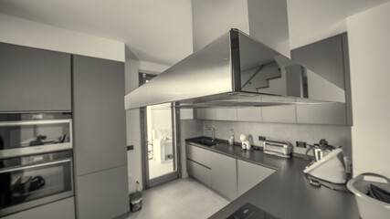 A modern kitchen with the hood in the foreground