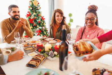 Woman serving food while hosting Christmas dinner party