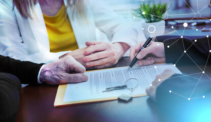 Realtor giving explanation to a couple about terms of investment contract (lorem ipsum text used); light effect