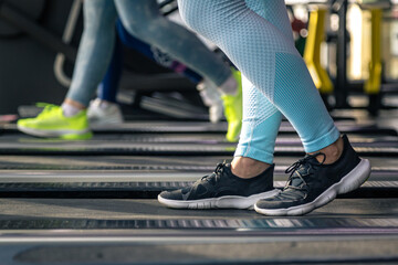 Woman's legs on a treadmill, shoes close-up, cardio workout. - obrazy, fototapety, plakaty