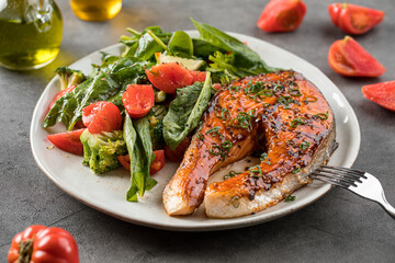 Portion of gourmet grilled salmon steak with vegetables