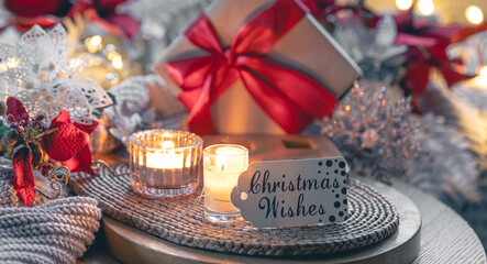 Christmas composition with gift box, candles and knitted element.