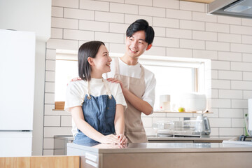 キッチンで笑顔の夫婦（料理・家事）