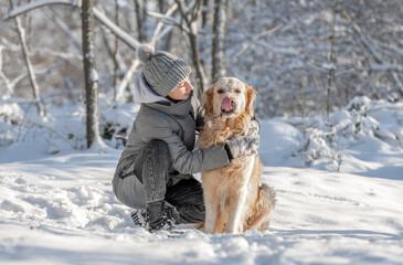 Girl, Teenager, And Golden Retriever Joyfully Play With Snow In Winter Forest