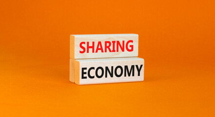 Sharing economy symbol. Concept words Sharing economy on beautiful wooden blocks. Beautiful orange table orange background. Business sharing economy concept. Copy space.