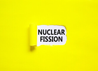 Nuclear fission symbol. Concept words Nuclear fission on beautiful white paper. Beautiful yellow paper background. Business science nuclear fission concept. Copy space.