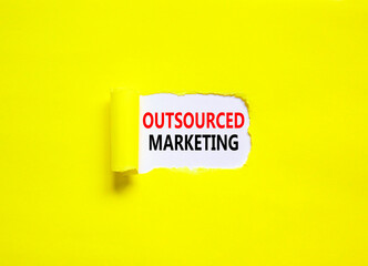 Outsourced marketing symbol. Concept words Outsourced marketing on beautiful white paper. Beautiful yellow paper background. Business Outsourced marketing concept. Copy space.