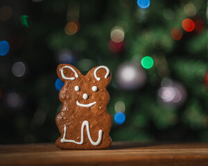 Christmas tree decorated with lights in the gingerbread background