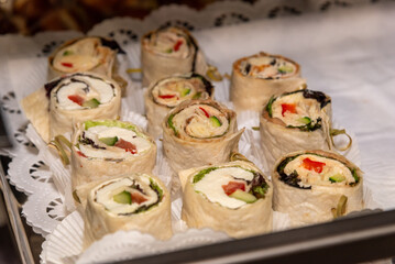 sliced wraps with cheese filling at a buffet