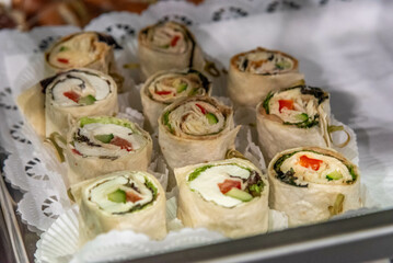 sliced wraps with cheese filling at a buffet