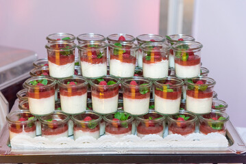 stacked glasses of pana cotta - desserts of raspberry jam and custard cream
