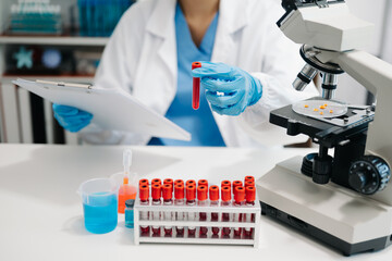 Female scientist researcher conducting an experiment working in the laboratory