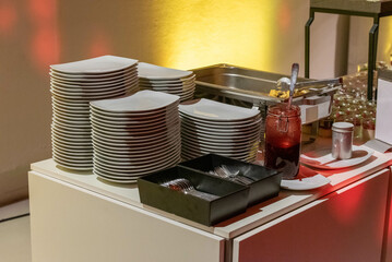 stack of plates at a buffet