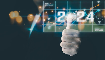 Fototapeta premium Businessman analyzes business growth plan in 2024, digital marketing strategy, revenue, profit, economy, stock market and business trends. Technical Analysis Strategies Using Future AI Technology