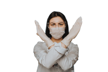 Nurse wearing protective glasses, a surgical mask and a medical gown crossed hands shows gesture stop  against transparent background. we need to stop coronavirus pandemic. Covid-19 virus concept.