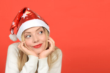 portrait of a pensive young woman in a Santa hat
