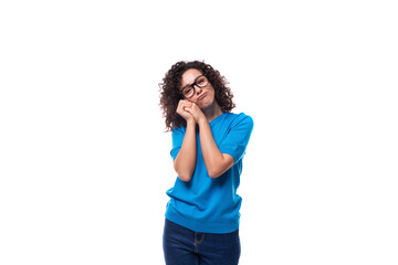 Fototapeta premium authentic slim young caucasian woman with curls dressed in a blue t-shirt and jeans