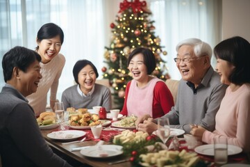 Asian family of 70 year old grand parents, 40 year old parents having a Christmas lunch in daylight, with a beautifully decorated living room with bright soft natural light coming from the windows - 687915181