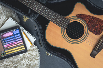 Fototapeta premium Acoustic guitar and digital tablet with a music application, top view.