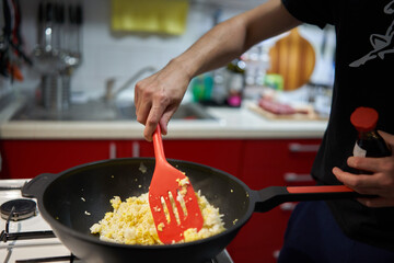 Man's hands making fried rice in a wok