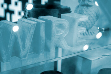 Objects letters printed on 3D printer close-up. Models letter 3D printed from molten plastic blue...