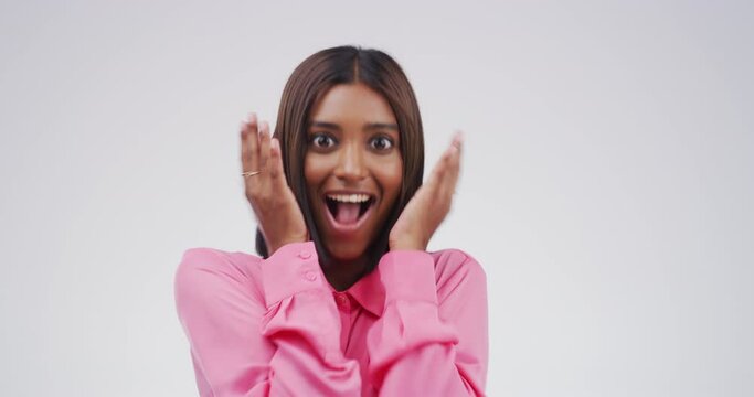 Excited, shock and face of woman in a studio with good news, promotion or winning deal. Surprise, smile and portrait of happy Indian female person from Canada with wow or omg face by gray background.