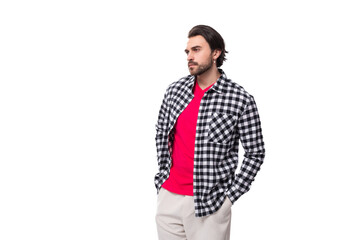 young european man with black hair and unshaven beard in a shirt on a white background with copy...