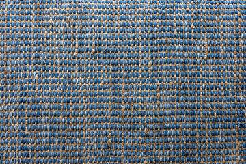Flat lay view of blue color braided jute rug, background texture concept.