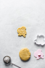 Top view of cut out raw sugar cookie dough shaped like santa, Christmas sugar cookie dough about to be baked, process of making sugar cookies