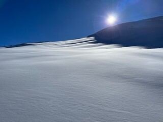 snowy mountain tops against dark blue ski from piz allalin saas fee valails wallis switzerland...